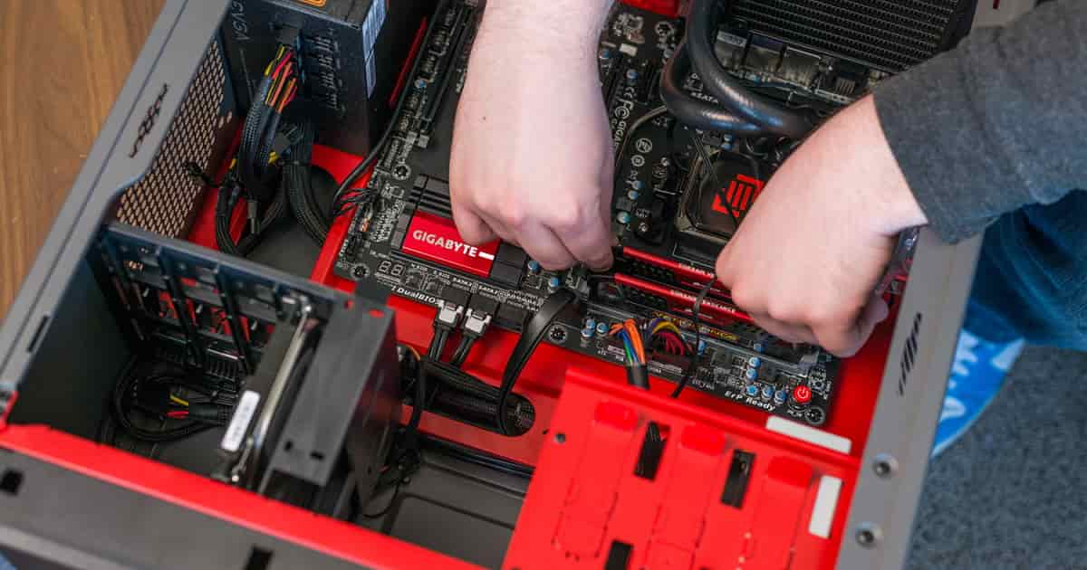 guy building a pc in a red pc case