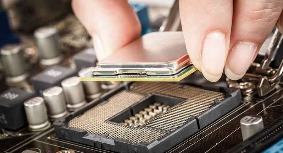 woman inserting a processor into a motherboard