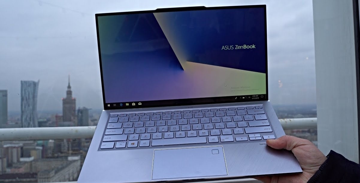 man holding asus zenbook